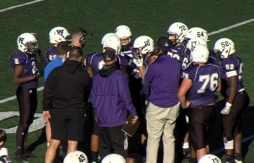 Wyoming high football coaches and players huddle 2020. (WKTV)